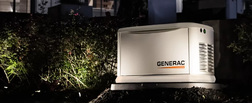 A generac generator outside of a home at night time.