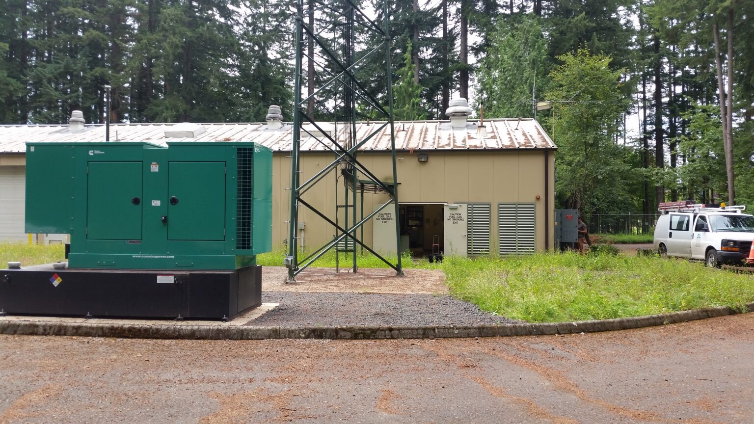 A green standby generator ready for backup power in rural Oregon