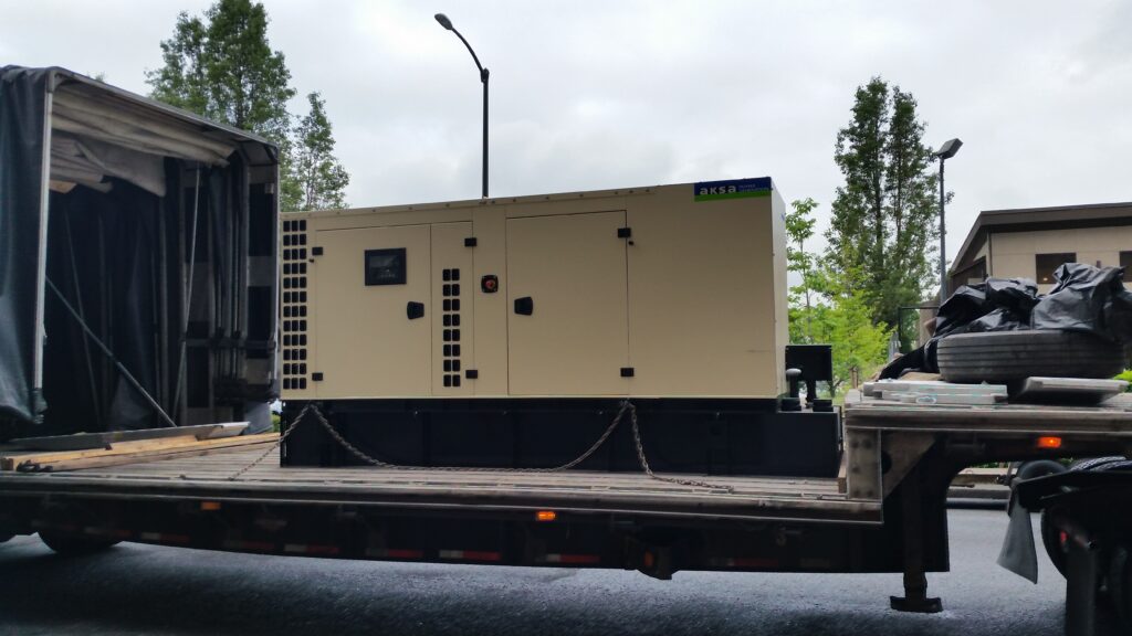 A commercial standby generator being transported for installation in Oregon