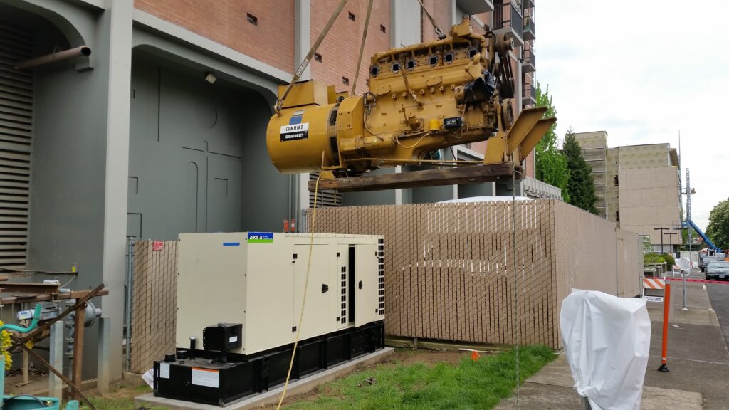 A yellow cummins generator being replaced with an ASKA standby generator
