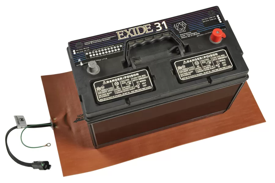 A battery on top of an orange battery heating pad from Hotstart Thermal Management