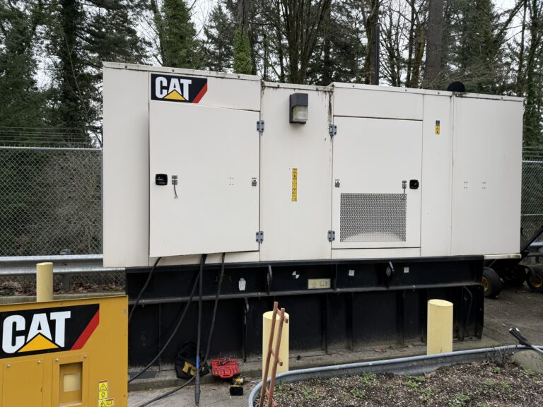 A gray Cat diesel generator being serviced