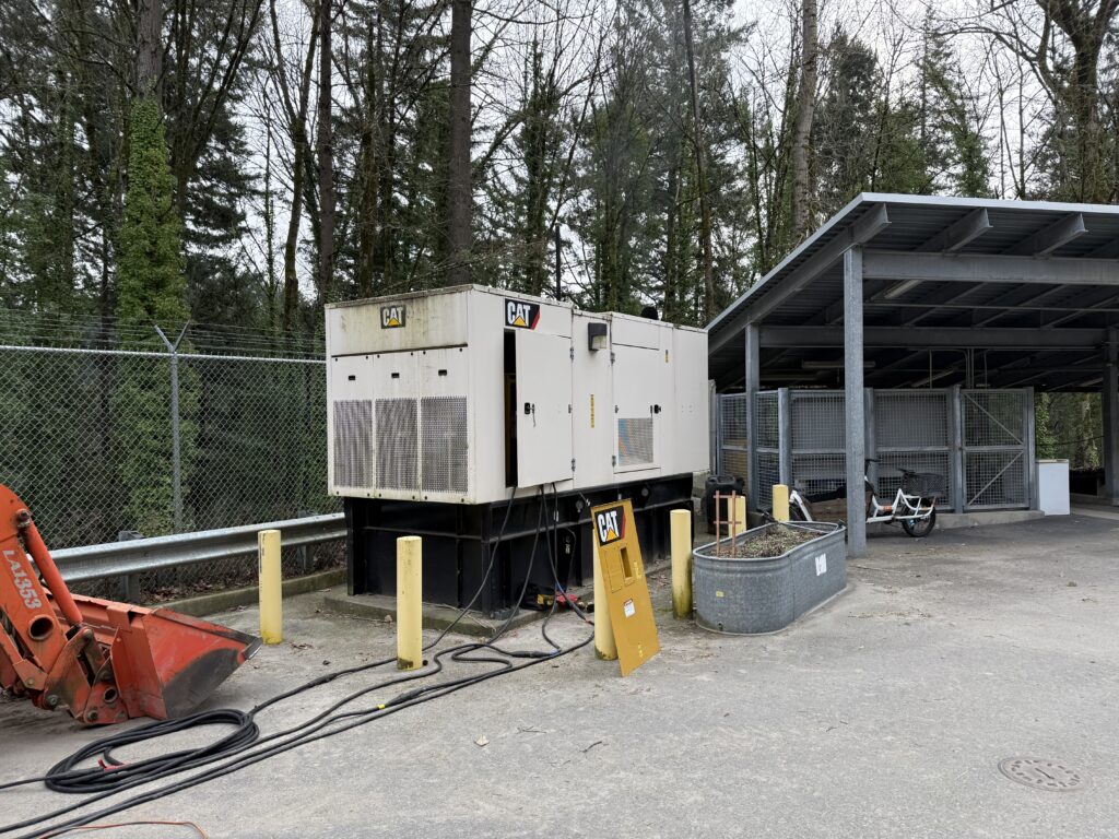 A Diesel Caterpillar generator with cables running from the engine to a load bank